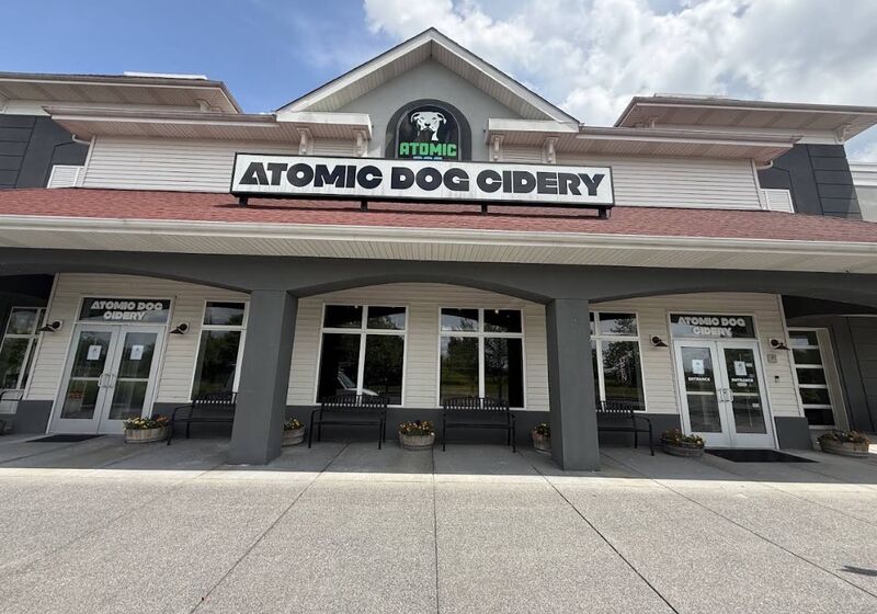 Restaurant and taproom storefront with cleaned concrete walkway, benches and entry doors